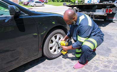 spare tires and automotive mechanic tools lay on roadside