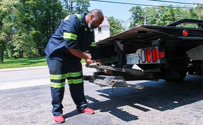 spare tires and automotive mechanic tools lay on roadside
